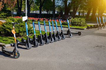 Electric scooters in the parking lot. Scooter rental for a trip around the city. © Sergii