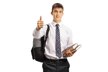 Teenage male student holding books and showing thumbs up