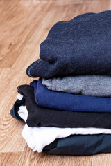 Stack of clothes on a wooden background