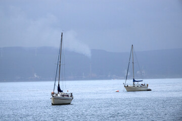 Fototapeta premium Boats with Port Talbort and steel factory in the background