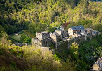 Fototapeta na wymiar Majestic Bouillon Castle and Semois river in belgian Ardennes seen from nearby observation point