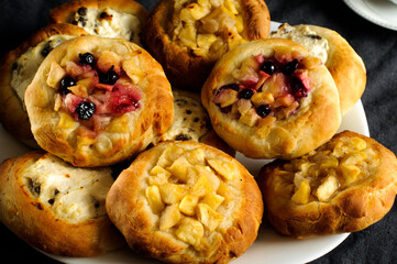 Hot homemade buns with cottage cheese and apples close-up. Selective focus, daylight