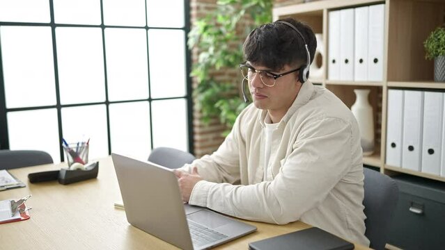 Young hispanic man business worker having online meeting stressed at office