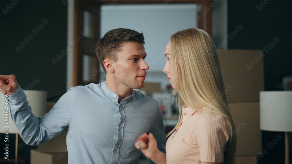 Wall mural aggressive man scolding woman in home close up. couple experiencing problems.