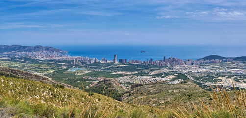 Benidorm city since of the mountains and sea on the background. Mediterranean coast landscape. Located in the valencian community, Alicante, Spain