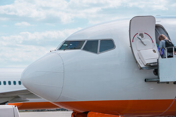 Airplane at airport, front fuselage close-up