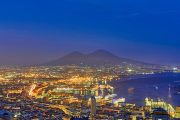 Aerial night view of Naples from the Vomero district. Castel Sant'elmo in the foreground while in the background the city's port and the Ovo castle.