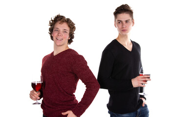 Two young attractive guys are drinking red wine. White background.	