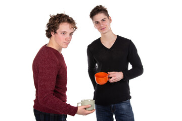 Two young attractive guys are drinking coffee. White background.	