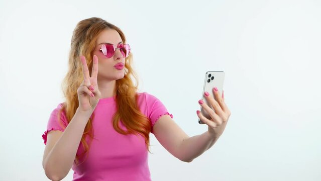 Selfie, pose and woman with phone, peace sign for social media post. Fashionable lady with mobile smartphone posing smiling, taking profile picture, studio shot isolated on white background