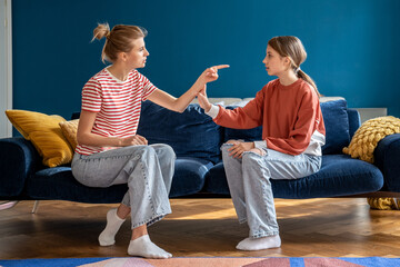 Stubborn teen girl daughter rejecting mother, upset worried woman mother dealing with difficult...
