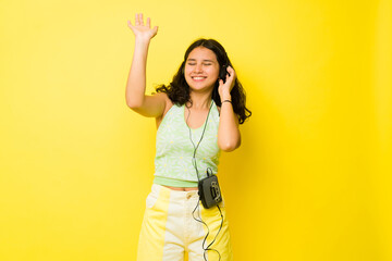 Excited teenage girl dancing listening to vintage retro music