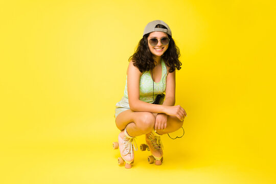 Fashion vintage teen girl roller skating with sunglasses