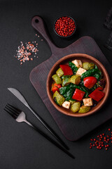Delicious fresh salad of zucchini, cheese, sweet peppers, spinach with spices and herbs