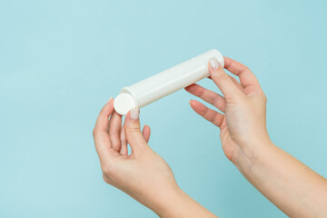 Packaging for vitamins, pills with tablet in hand. White tube. Mockup