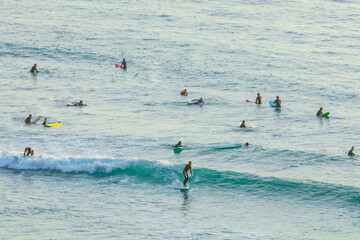 Silhouette Of surfer people on sunset beach catch oceans wave.Surfing sport and travel concept