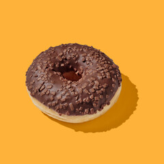 Chocolate donut on yellow pastel background