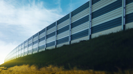 noise barriers on a motorway on a sunny day - 600558393
