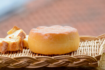Spanish hard smoked cow cheese from Pria, Asturias, served outdoor with view on San Lorenzo beach in Gijon