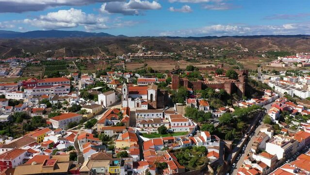 View of Silves town buildings with famous castle and cathedral, Algarve region, Portugal. Walls of medieval castle in Silves town, Algarve region, Portugal.