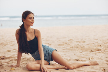 Fototapeta na wymiar sea woman body nature smile sitting sand beach travel freedom vacation