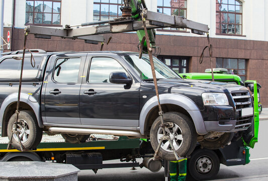 Car tow truck lifted car for loading.