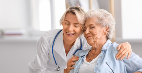 Doctor visiting happy senior woman at home