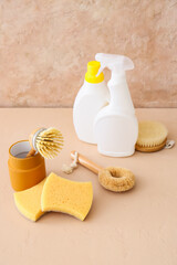 Set of natural cleaning supplies on beige background