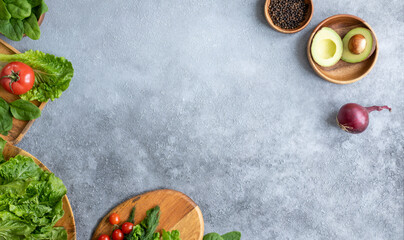 Lettuce, tomato, parsley, avocado and onion on a gray background. The concept of vegetarian food, healthy lifestyle and nutrition