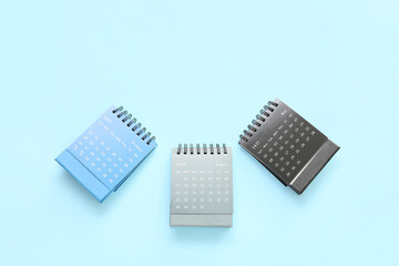 Flip paper calendars on blue background