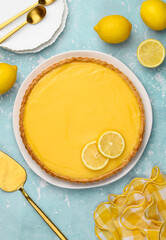 Lemon tart on a plate on a blue background. Healthy citrus dessert. Top view