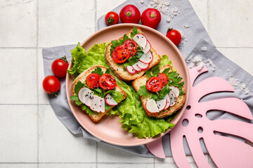 Plate with delicious radish bruschettas on white tiled table