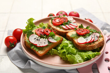 Plate with delicious radish bruschettas on white tiled table