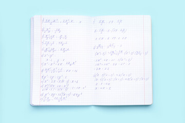 Copybook with maths formulas on blue background