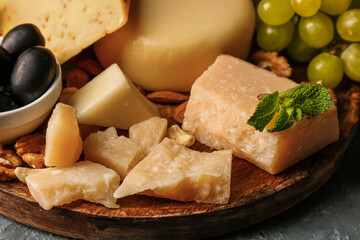 Plate with different types of tasty cheese on table, closeup