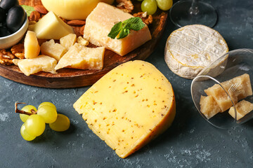 Different types of tasty cheese on blue background