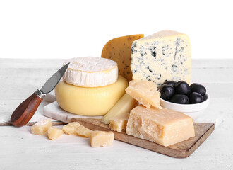 Board with different types of tasty cheese on table against white background