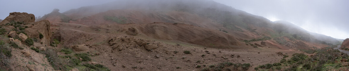 Huge panorama landscape of road in orange foggy mountains desert, resembling mars and dune, in tenerife, canarias, spain	