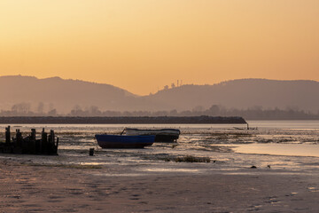 Naklejka premium the Calm Water of the Ria Reflecting the Sun and the Clouds