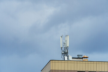 New GSM antennas on the roof of a residential building in the city for transmitting a 5g signal are a danger to human health. Radiation pollution of the environment through cell towers.