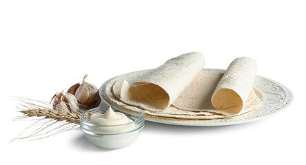 Plate with thin lavash, spikelet, garlic and sauce on white background