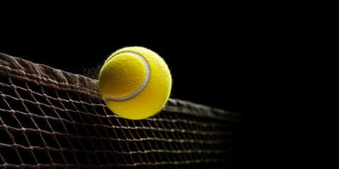 Yellow tennis ball flying into the tennis net on black background. Banner with free space for text. Generated by AI - obrazy, fototapety, plakaty
