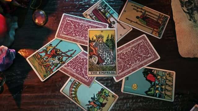 Paris, France - April 20, 2018. Using a card displaying regal Empress for witchcraft ritual. Witchcraft ritual for divination of regal dynasty future. Fortune-telling witchcraft ritual. Regal art