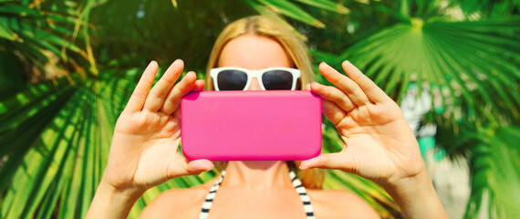 Summer portrait close up woman stretching her hands taking selfie picture with smartphone on the...