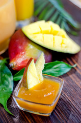 Fresh sauce, mango fruit dressing in a glass dish on the table close-up.