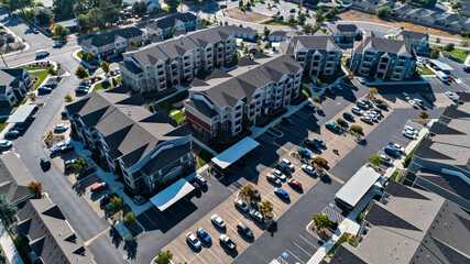 Aerial view of an apartment complex a large parking lot