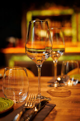 Clear wine glasses on the wooden table in restaurant.