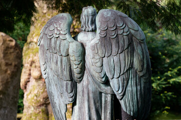 rear view of wings of an angel figure in a historical cemetery