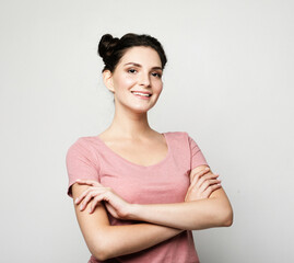 Fototapeta premium Portrait of cheerful pretty young brunette woman wearing casual over grey background