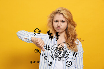 Complaint. Dissatisfied young woman showing thumb down gesture on yellow background, Different...